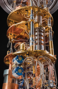 a cilinder with three gold discs with lots of wires and tubes.